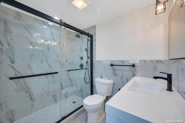 bathroom with vanity, an enclosed shower, tile walls, and toilet