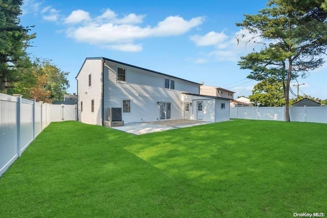 back of house with a lawn, a patio area, and central AC