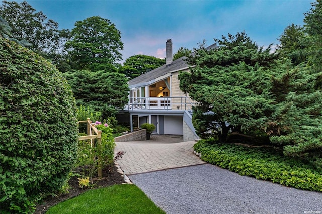 view of front of property featuring a garage and a balcony