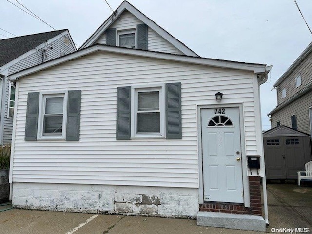 view of front of house with a storage unit