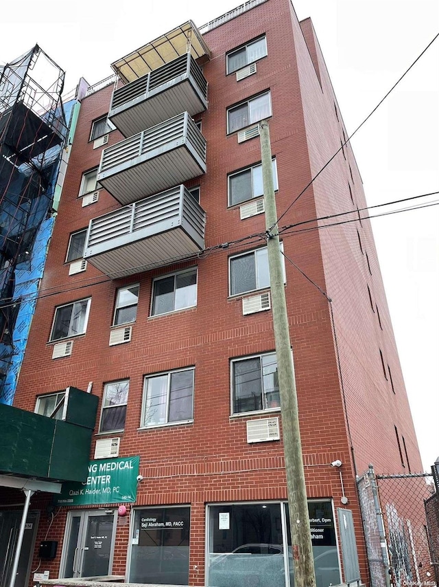 view of building exterior with a wall mounted air conditioner