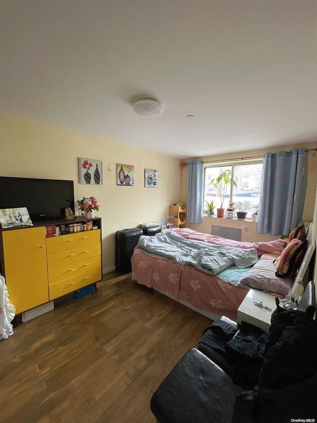 bedroom with dark hardwood / wood-style flooring