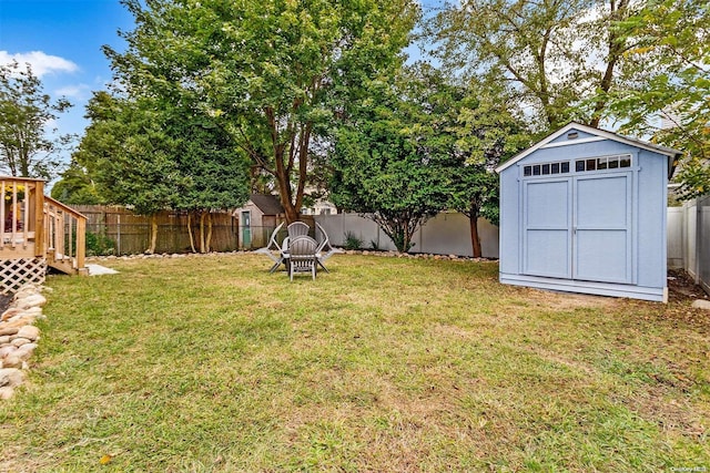 view of yard featuring a storage shed and a wooden deck