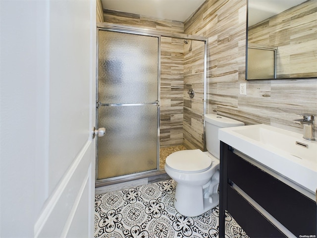 bathroom featuring vanity, toilet, and an enclosed shower