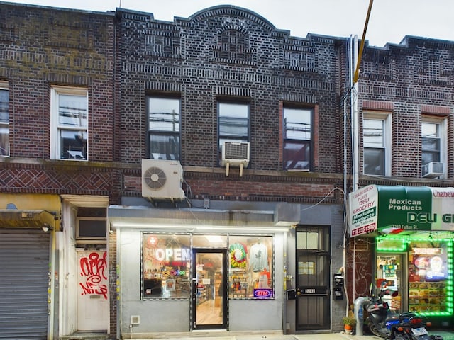 view of building exterior with ac unit and cooling unit