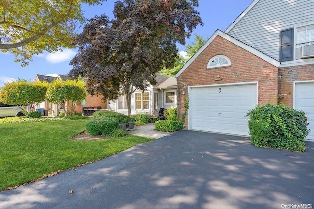 view of front of house featuring a front yard and a garage