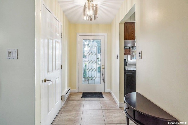 doorway to outside with light tile patterned flooring, a baseboard radiator, and a chandelier