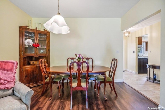 dining space with a chandelier and hardwood / wood-style flooring