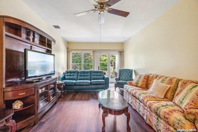 living room with ceiling fan and dark wood-type flooring