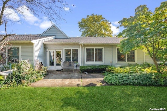 rear view of property featuring a patio area and a yard