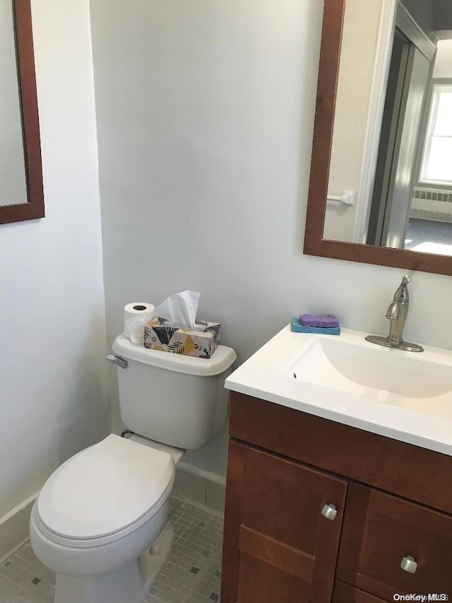 bathroom featuring tile patterned flooring, vanity, and toilet