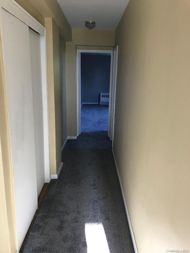 corridor with dark colored carpet