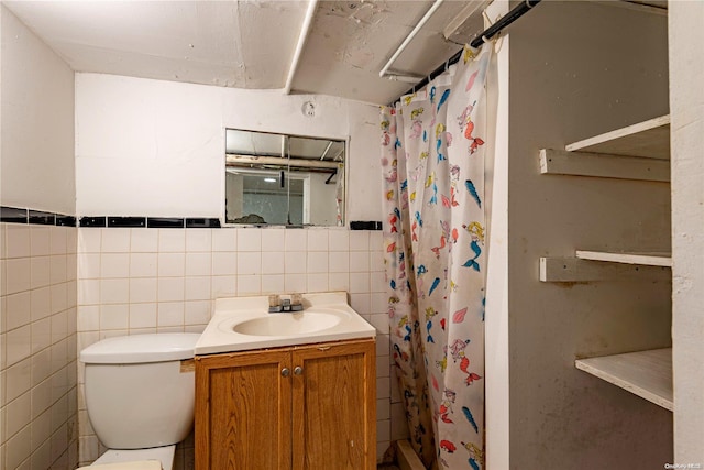 bathroom with vanity, toilet, tile walls, and curtained shower