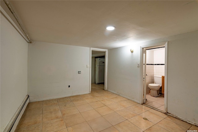 interior space with light tile patterned floors and a baseboard radiator