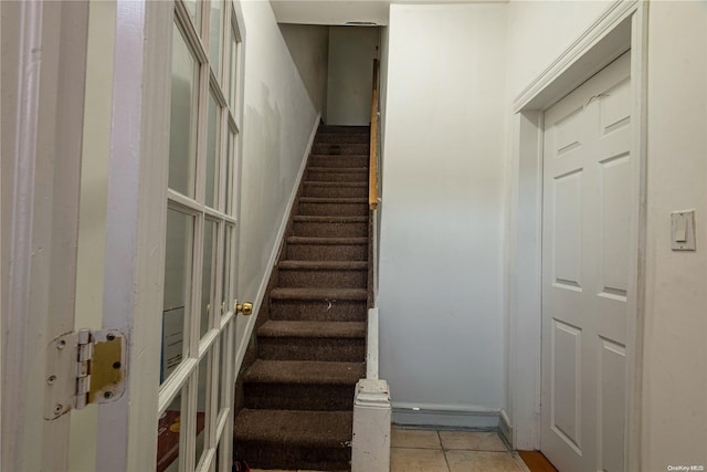 stairway featuring tile patterned floors