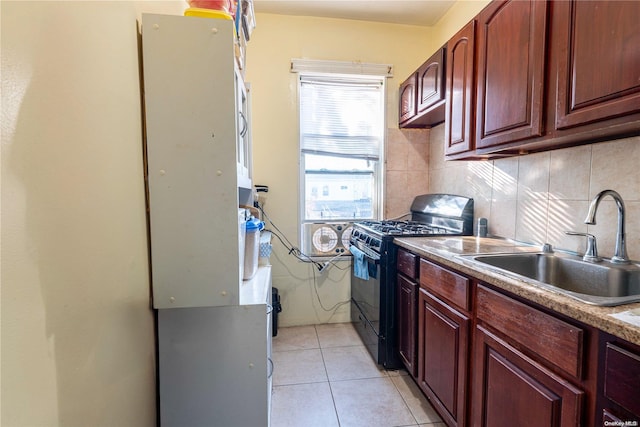 kitchen featuring black gas range, light tile patterned floors, sink, and tasteful backsplash