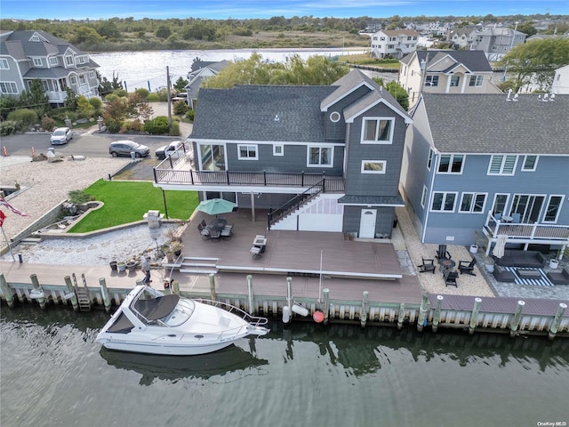 back of house with a deck with water view