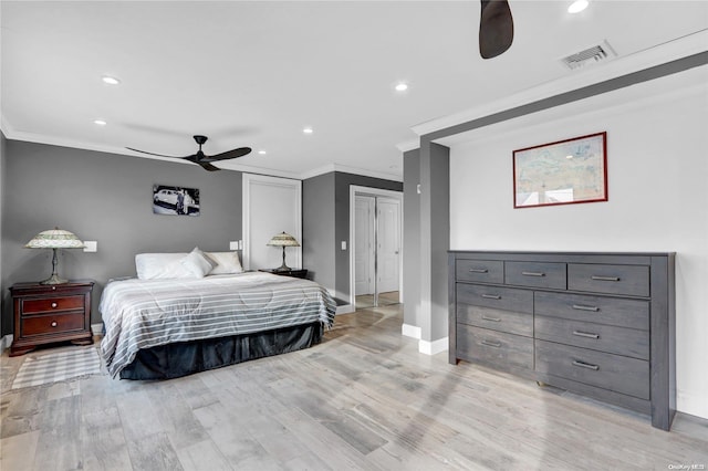 bedroom featuring ceiling fan, light wood-type flooring, and ornamental molding