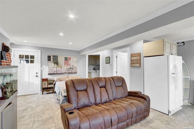 living room with washer / dryer and ornamental molding