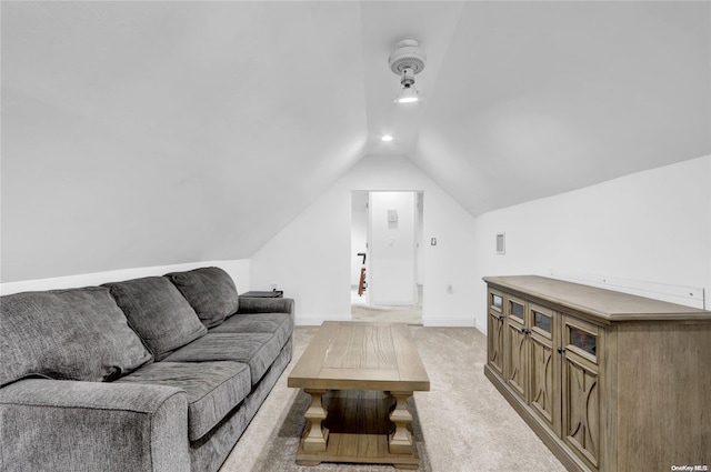 carpeted living room featuring vaulted ceiling