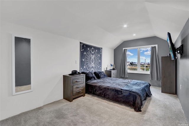 bedroom featuring light carpet and vaulted ceiling