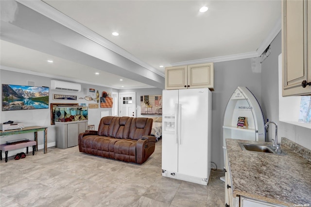 kitchen with sink, white refrigerator with ice dispenser, a wall unit AC, crown molding, and cream cabinets