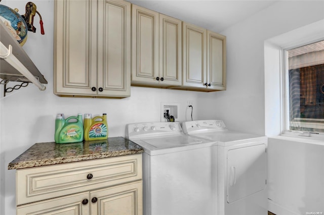 washroom featuring cabinets and separate washer and dryer