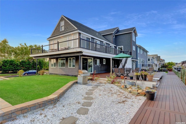 exterior space with a balcony and a lawn