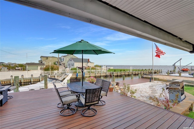 deck with a dock and a water view