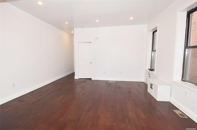 empty room with dark wood-type flooring