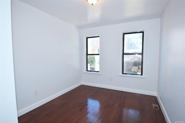 unfurnished room featuring dark hardwood / wood-style floors