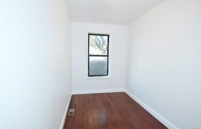 spare room with dark hardwood / wood-style floors