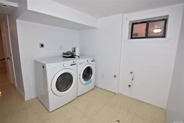 clothes washing area with washer and clothes dryer