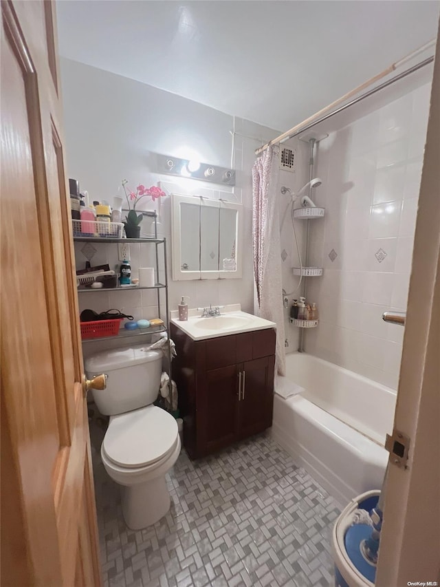 full bathroom with shower / bath combo, vanity, and toilet