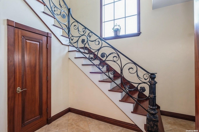 stairway with tile patterned flooring