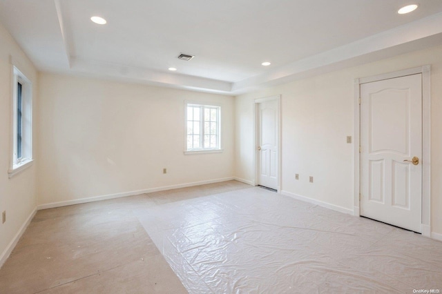 unfurnished room with a raised ceiling