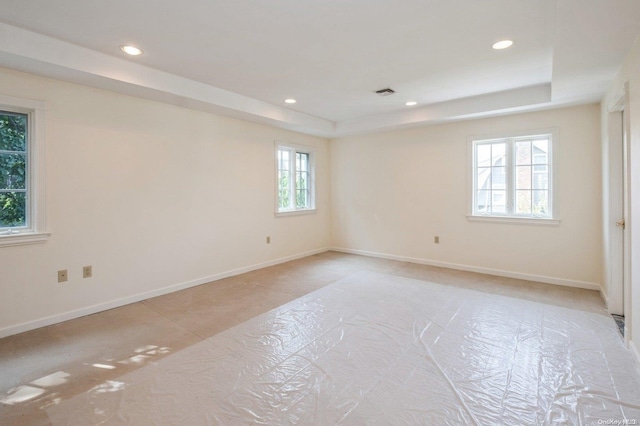 spare room with a tray ceiling