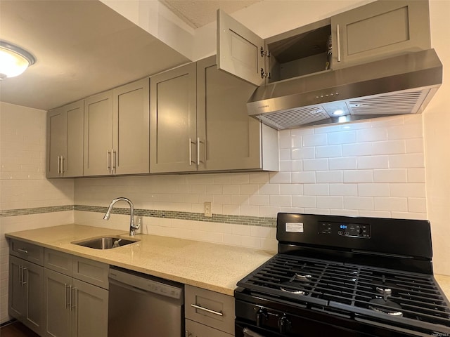 kitchen with gray cabinetry, tasteful backsplash, dishwasher, black range with gas cooktop, and sink