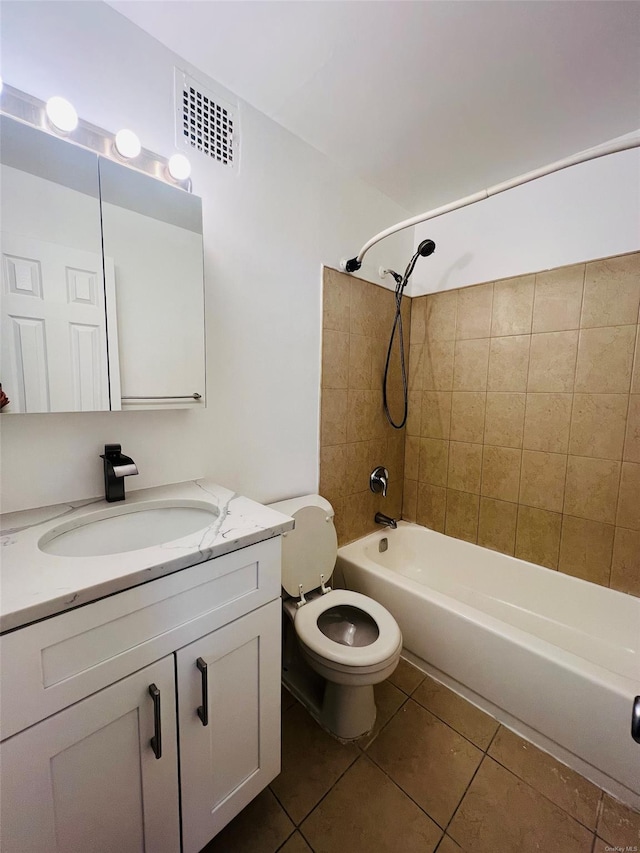 full bathroom featuring toilet, tile patterned flooring, tiled shower / bath combo, and vanity