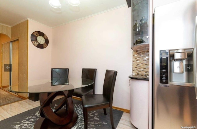 dining room featuring light wood-type flooring and ornamental molding