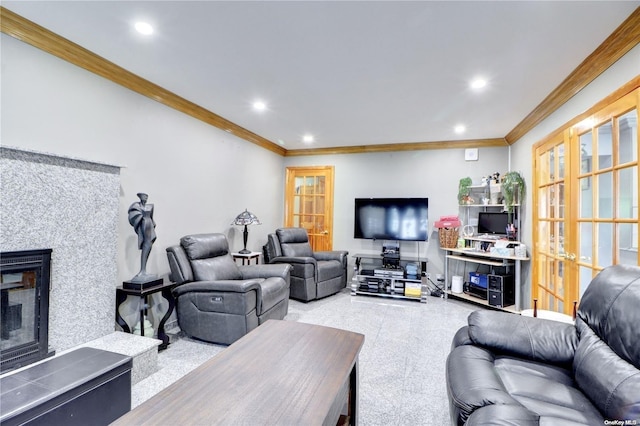 living room featuring a tile fireplace, crown molding, and french doors