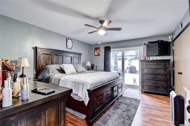 bedroom with ceiling fan, light hardwood / wood-style floors, and access to exterior