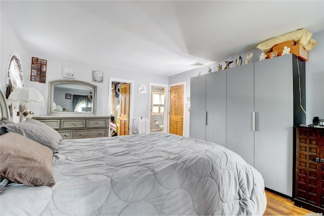 bedroom with light wood-type flooring and a closet