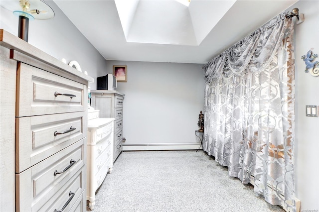 interior space with baseboard heating and a tray ceiling