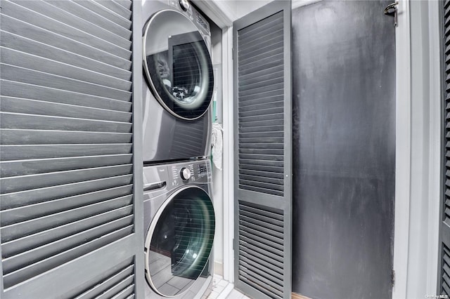 laundry area featuring stacked washer / drying machine