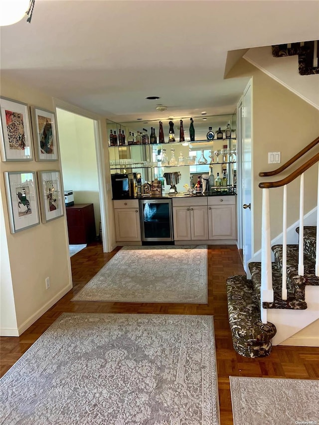 bar with wine cooler and parquet floors