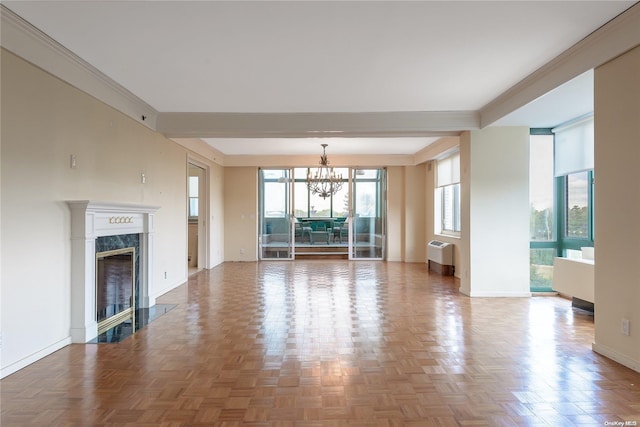 unfurnished living room featuring radiator, parquet floors, crown molding, a fireplace, and a chandelier