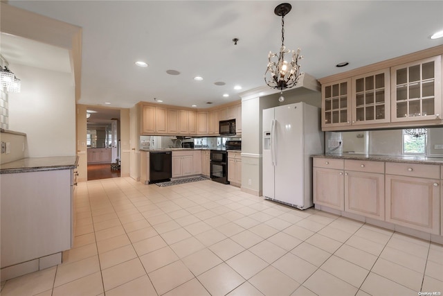 kitchen with black appliances, decorative light fixtures, light brown cabinets, and a chandelier