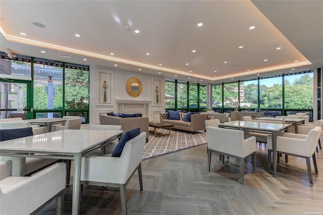 dining room with parquet floors and a tray ceiling