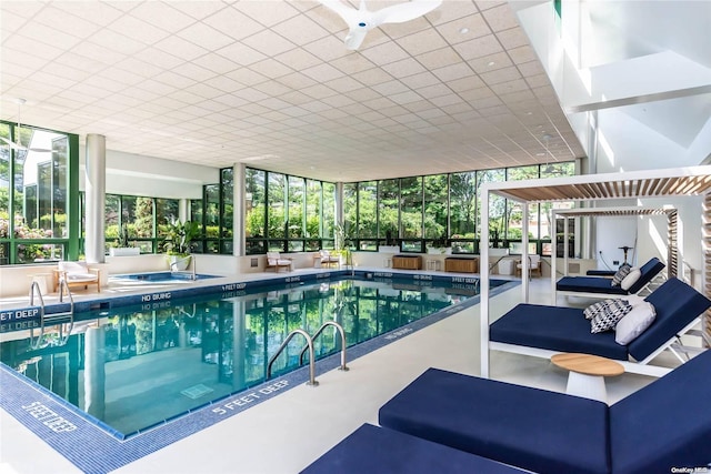 view of swimming pool featuring a patio area, ceiling fan, and an indoor hot tub